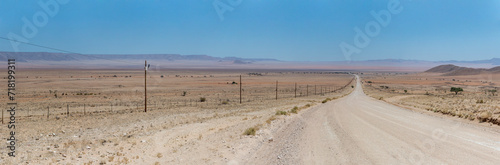 C13 gravel road and colorful flatland in Naukluft desert, north of Aus,  Namibia