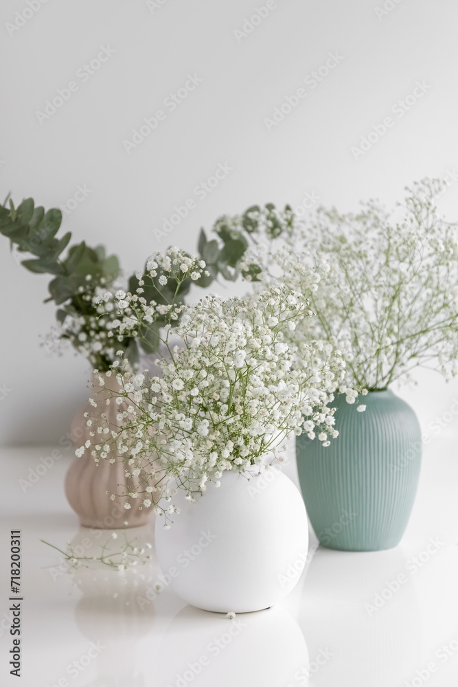 Gypsophila in vase. Three vases with flowers. Eucalyptus. Card. Photo Gypsophila in vase. Three vases with flowers. Eucalyptus. Card. Photo