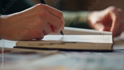 Woman hands closing notepad putting pen inside closeup. Girl finish noting plan.