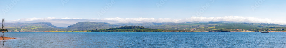 Lake Furnas during a beautiful sunny day, with a view of the Serra da Canastra in the background. Panoramic view of Lake Furnas, in the interior of Minas Gerais, Brazil.