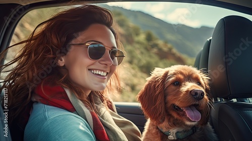 joy of an adorable dog and a happy woman looking out of a car window in the mountains.