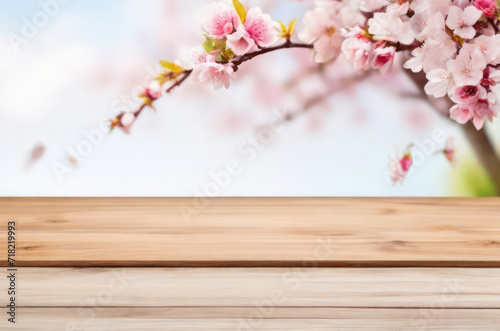 wooden table top with pink spring flowers © Olha Vietrova