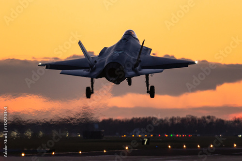 A Lockheed Martin F-35 Lightning II fifth generation fighter jet is ready to land during a beautiful sunset. 
