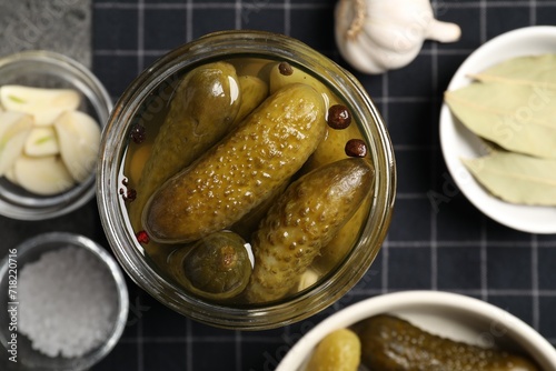 Tasty pickled cucumbers in glass jar on table, top view