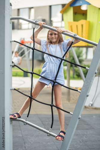 Girl Climbing on Outdoor Playground Equipment