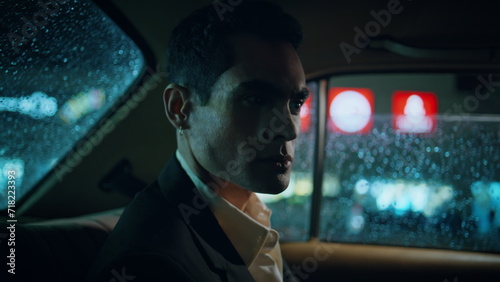 Focused manager turning window rainy evening closeup. Businessman riding vehicle © stockbusters