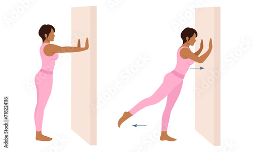 A woman does exercises near the wall. Wall Pilates.