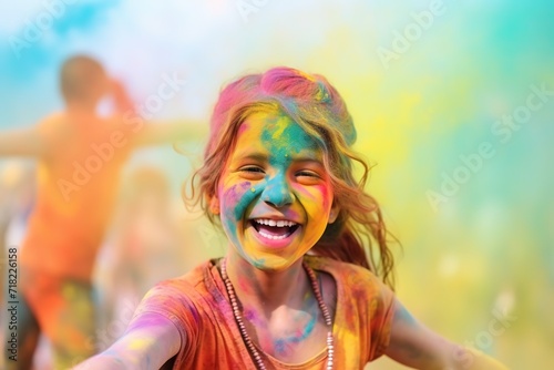 happy child at holi festival, colors of joy , vibrant celebration, youth activities, blurred colorful powder air background. © Jim1786