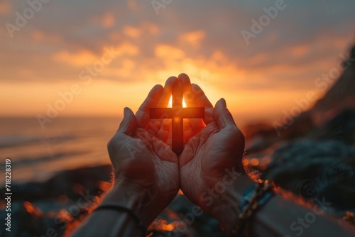 Hands holding a crucifix  a believer praying with his arms crossed  Jesus Christ  divine light from heaven