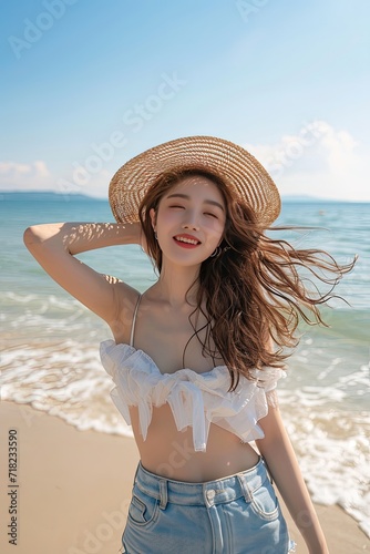 Wallpaper Mural With the sand beneath her feet, she dances her way to pure happiness. Young Asian woman wearing straw hat. Torontodigital.ca