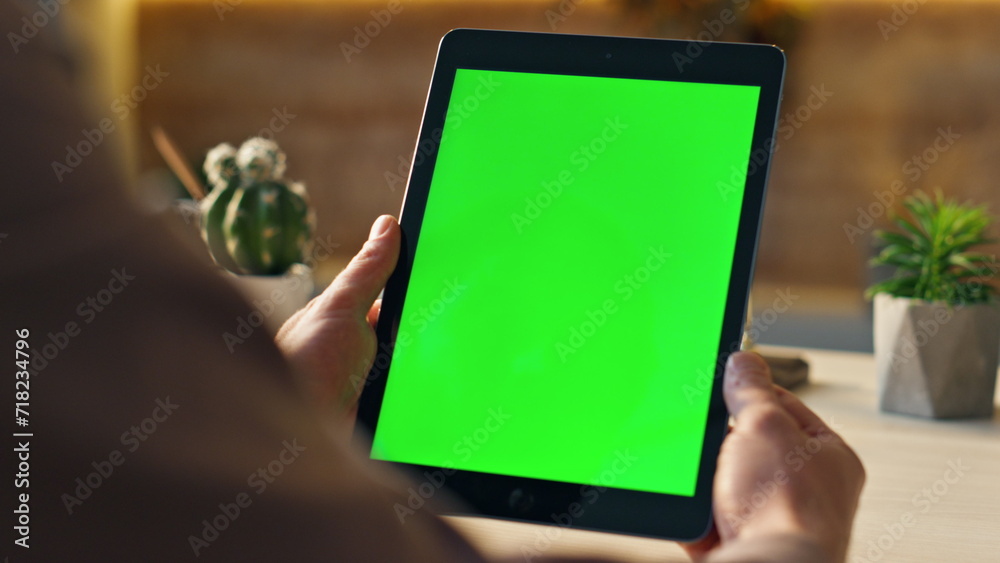 Unknown freelancer looking green screen tablet at desk close up. Man holding tab - obrazy, fototapety, plakaty 