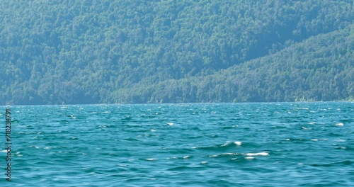Exploring Nature's Majesty.  A High-Resolution Video Capturing the Serenity of a Deep Blue Lake and Majestic Mountains from a Boat, with Crisp Daylight Illuminating the Pristine Landscape