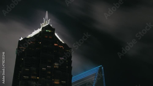 Top of Jin Mao Tower skyscraper at cloudy evening. Timelapse photo