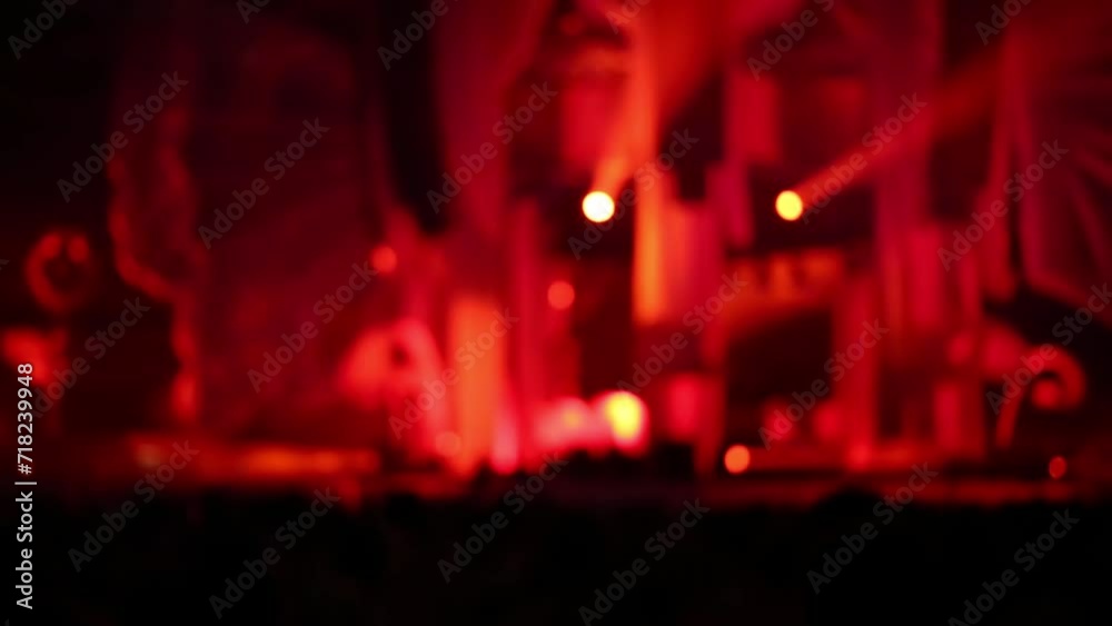 Red light from flickering lights among crowd of dancing people