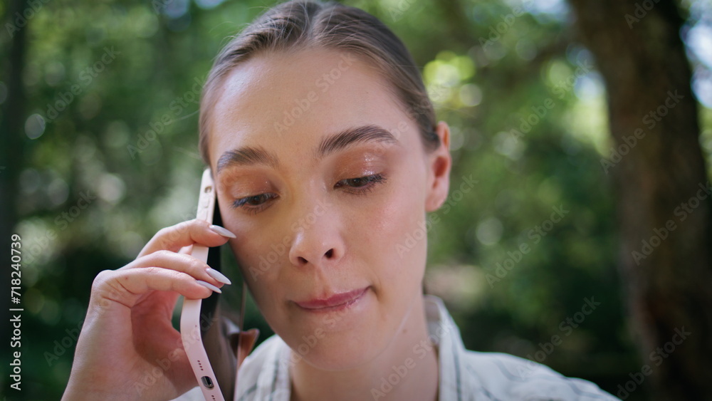 Serious woman have phone conversation in park close up. Girl talking smartphone Serious woman have phone conversation in park close up. Girl talking smartphone