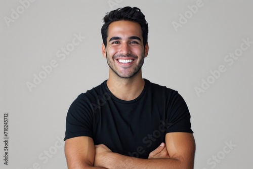 A picture of a man with a smiling face and his arms crossed. This image can be used to portray confidence, professionalism, and a friendly demeanor
