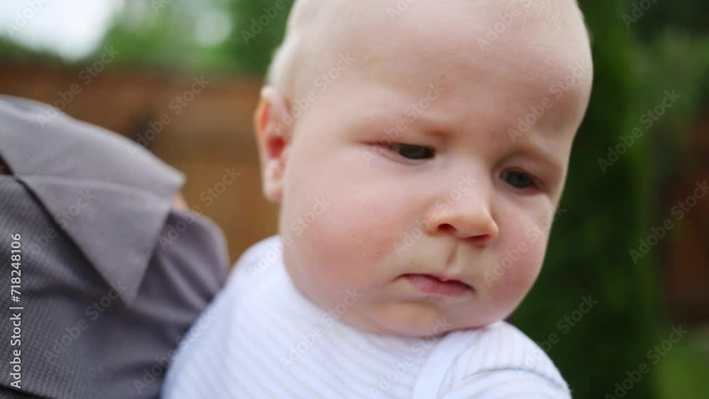 Closeup portrait of little cute baby on shoulder of parent Closeup portrait of little cute baby on shoulder of parent