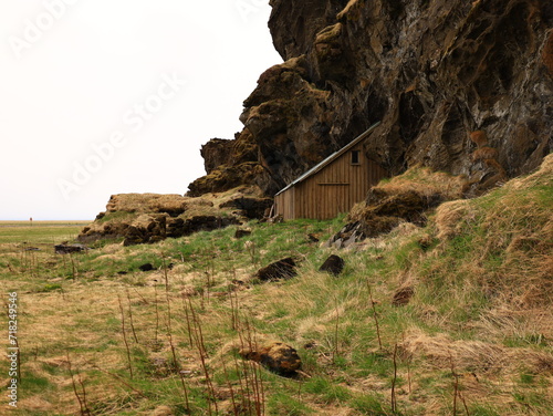 Drangurinn í Drangshlíð is a characteristic tuff rock formation that stands alone on the grazing land of Drangshlíð farm photo