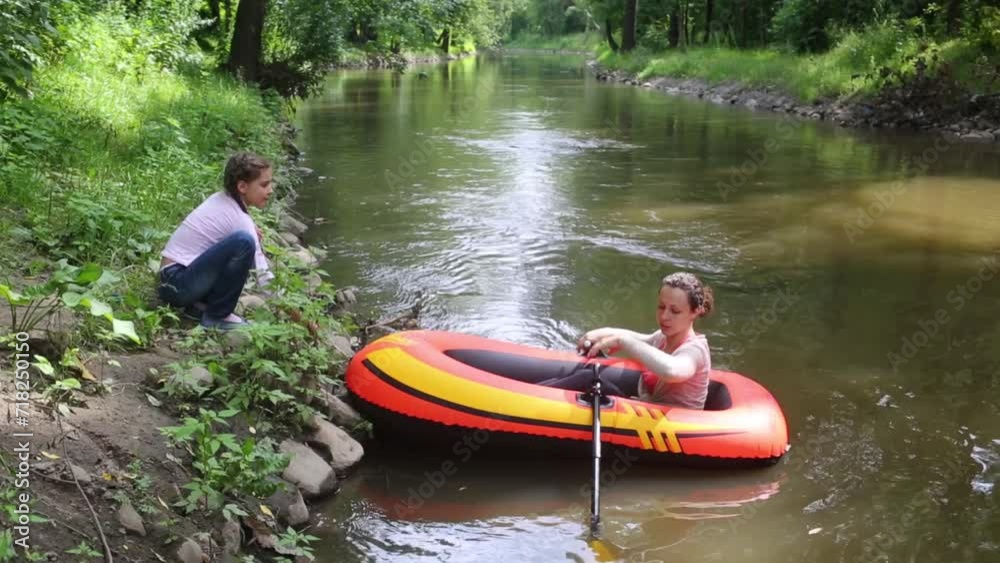 Woman sits in a boat and preparing to float, boat girl holding a rope Woman sits in a boat and preparing to float, boat girl holding a rope