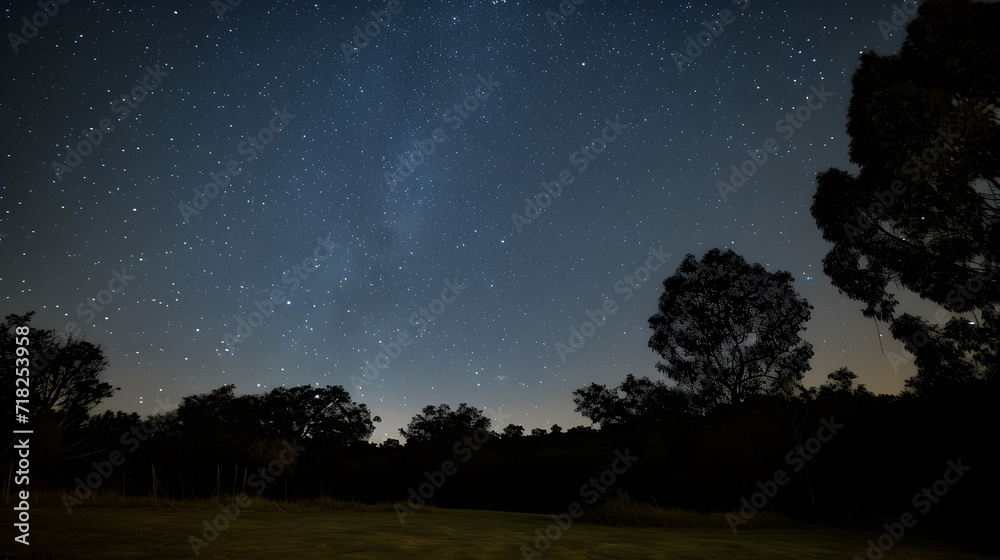 Starry Night Sky over Tranquil Countryside Landscape