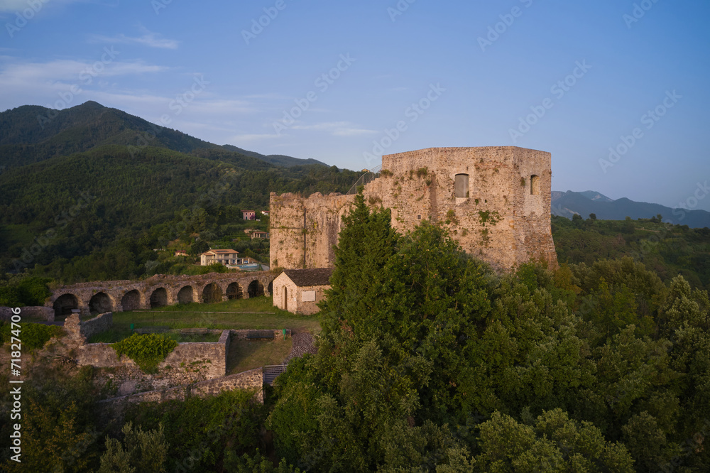 This high-resolution image showcases the historical castle against the stunning landscape. Capture the panoramic beauty of Aghinolfi Castle in Montignoso, Italy, through stunning drone photography.