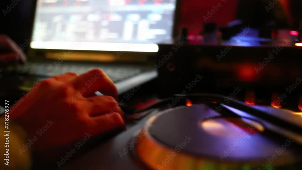 DJ hand next to laptop, turntable and panel mixer close up at club. DJ hand next to laptop, turntable and panel mixer close up at club.