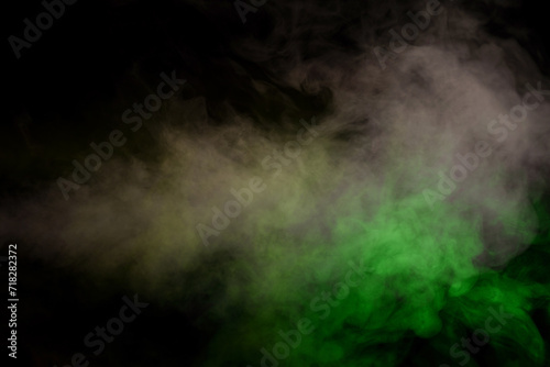 Red and green steam on a black background. © Nikolay