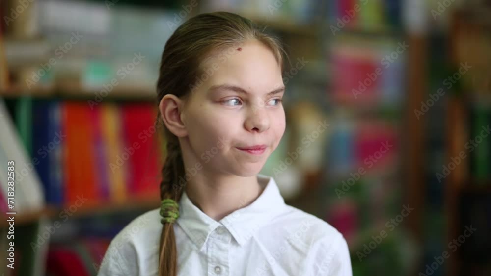 Girl with pigtail looking to front and to side in the library Girl with pigtail looking to front and to side in the library