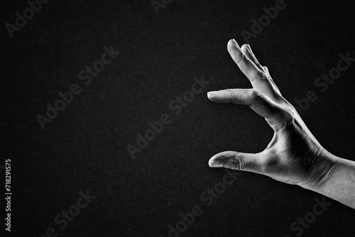 Photos Hand Holding Something Sign in Black and White on Textured Paper Background, Cop