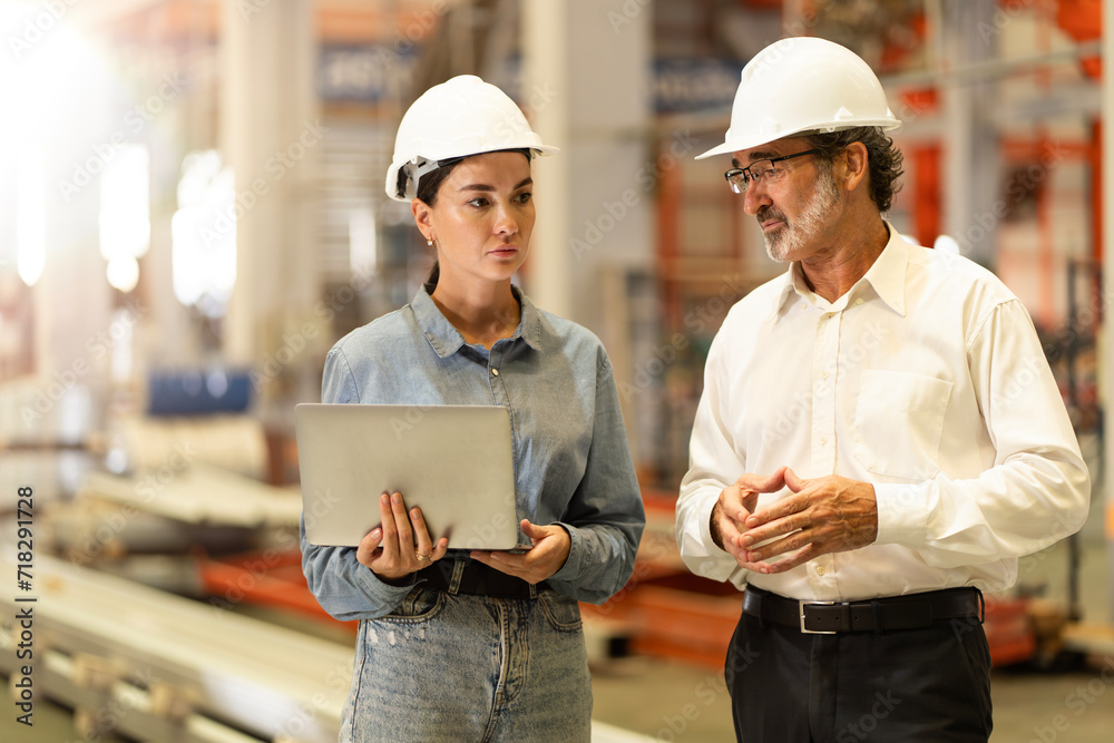 © Montri - two professional engineer,worker,technician use clipboard discuss work, walk in steel metal manufacture factory plant industry. Black African American man and woman wear hard hat check quality machine © Montri - two professional engineer,worker,technician use clipboard discuss work, walk in steel metal manufacture factory plant industry. Black African American man and woman wear hard hat check quality machine