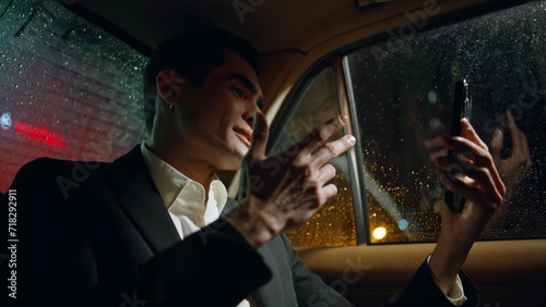 Speaking businessman video calling telephone vehicle closeup. Man gesturing hand © stockbusters