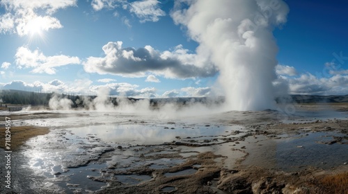  a large geyser spewing water into the sky near a body of water with steam coming out of it's sides and a mountain in the distance.