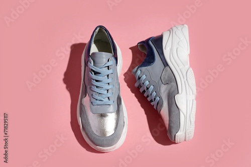 women's sneakers on a colored pink background top view. Women's shoes