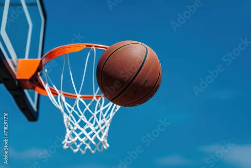 Basketball landing on the basket © Tisha