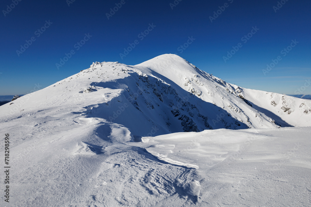 Chopok, Low Tatras, Nizke Tatry, Slovakia. Beautiful winter landscape of mountains is covered by snow in wintertime. Sunny weather with clear blue sky and white snow. 