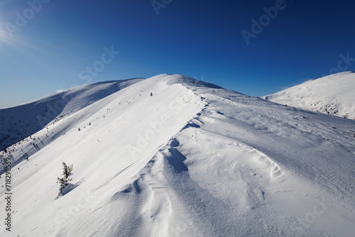 Panska Hola, Low Tatras, Nizke Tatry, Slovakia. Beautiful winter landscape of mountains is covered by snow in wintertime. Sunny weather with clear blue sky and white snow.  © M-SUR