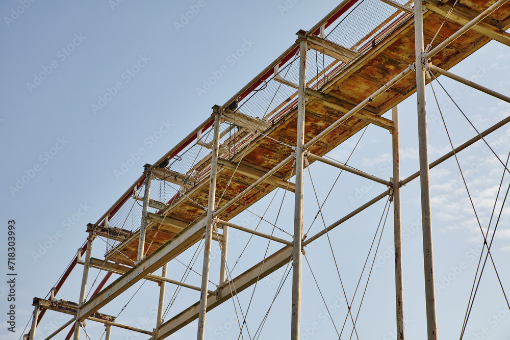 Rusted Roller Coaster Framework, Safety Netting, Blue Sky Perspective