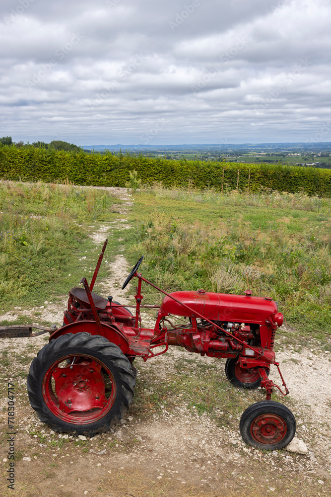 Red tractor near Monbazillac castle (Chateau de Monbazillac), Dordogne department, Aquitaine, France Red tractor near Monbazillac castle (Chateau de Monbazillac), Dordogne department, Aquitaine, France