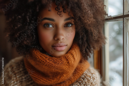 African American young woman with curly hair in warm clothes
