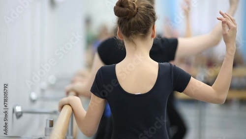 Little girls are training whirl and curtsy at the ballet class. photo