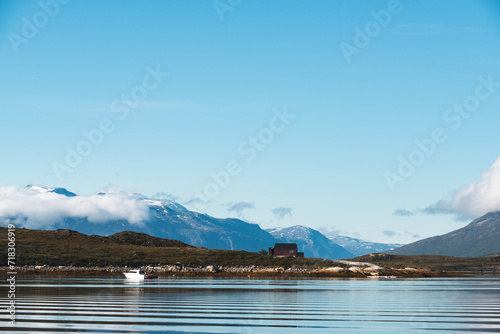 Photo of Greenland's nature, with a boat and a cottage,