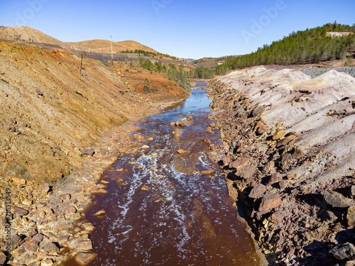 Aerial drone view of Tinto river in Huelva mountains. Red coloration has its origin in the weathering of minerals containing heavy metal sulfides found in deposits along the river and at its source photo