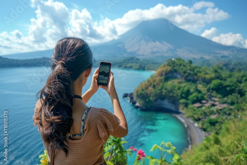 Girl recording with her cell phone vertically a beautiful landscape. Travel concept, social networks