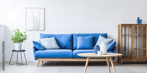 Blue couch and wooden coffee table in white apartment