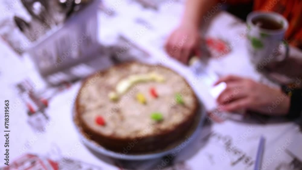 Round cake, decorated with pieces of marmalade at table. Round cake, decorated with pieces of marmalade at table.