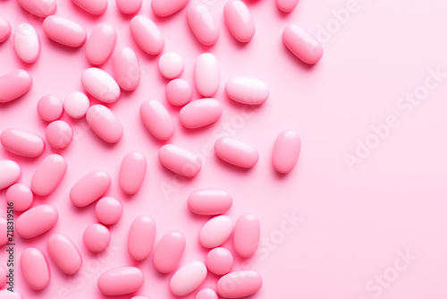 Closeup of pink candy hearts and sweets in shape of love symbol on pink background, for Valentine's day