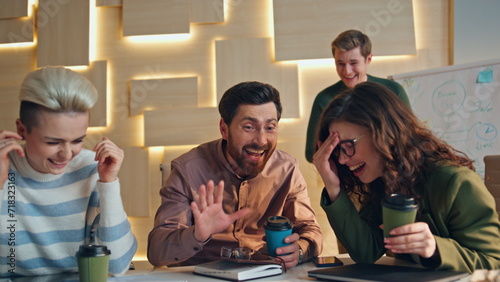 Colleagues laughing coffee break in workspace closeup. Friendly communication photo