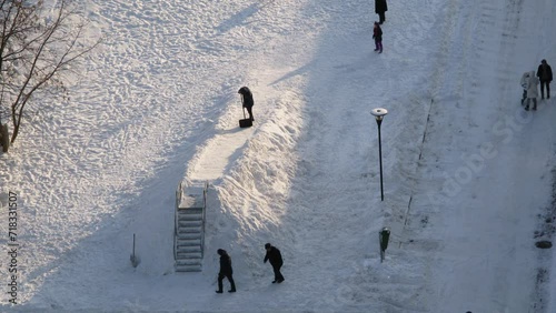 People with spades make ice coaster at winter day. Timelapse photo