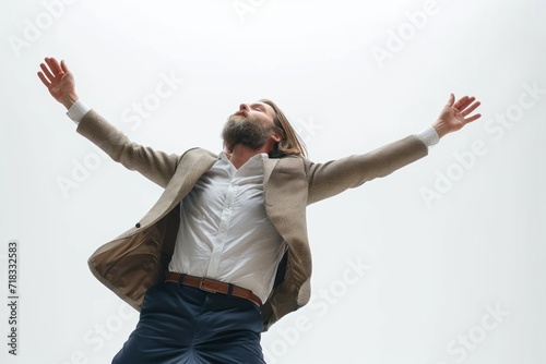 Cool businessman with beard dancing against white background