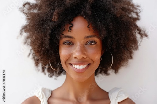 Happy young woman with Afro hairstyle against white background